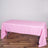 Pink tablecloth draped over a folding table in a studio setting.