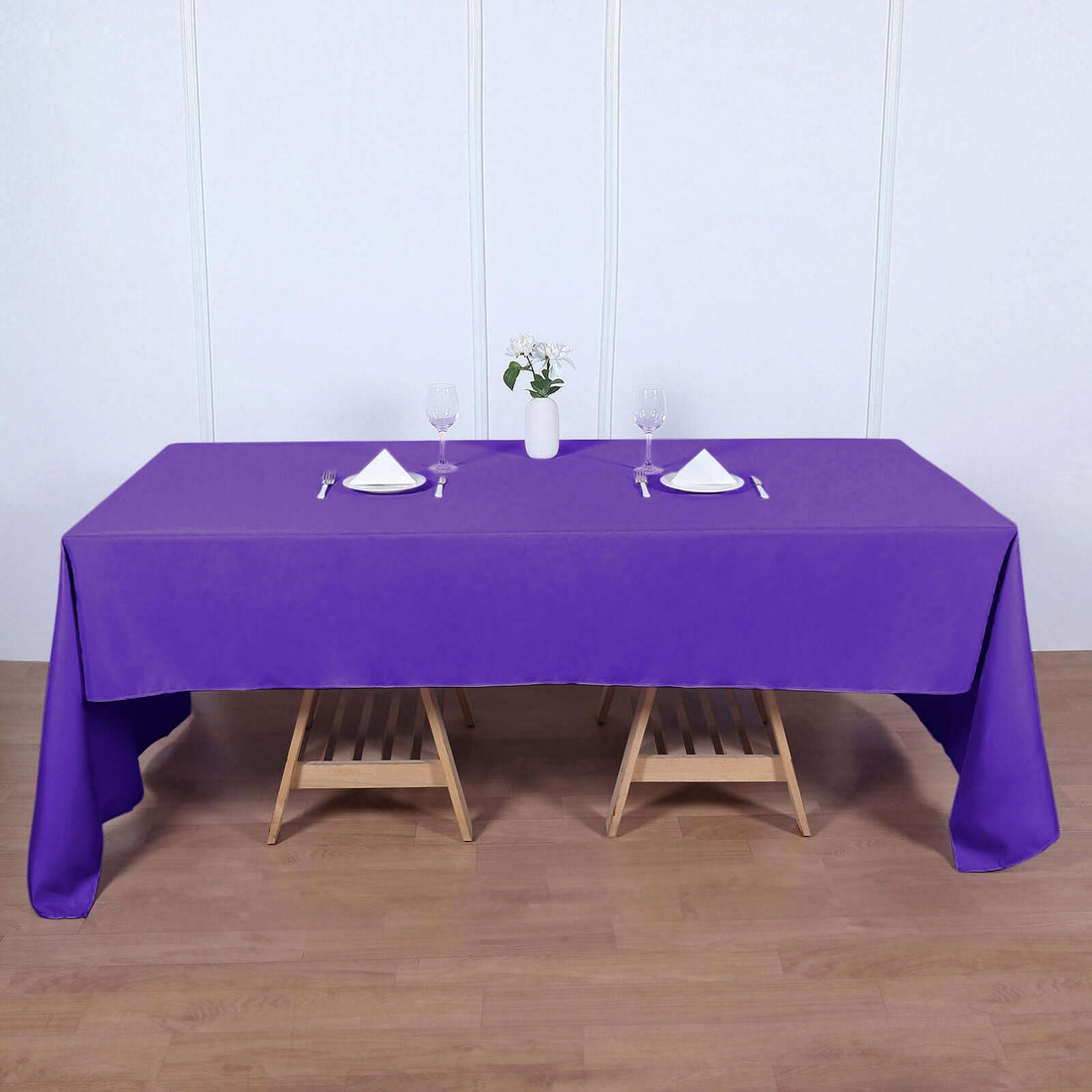 Purple tablecloth draped over a table set for dining.