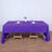 Purple tablecloth draped over a table set for dining.