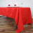 Red tablecloth draped over a table set for dining.