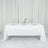 Elegant dining table set with white tablecloth and floral centerpiece