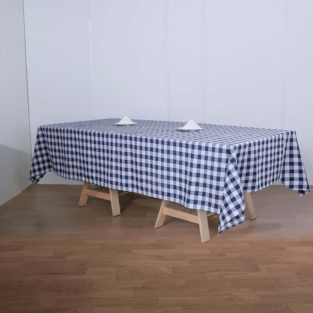 Blue and white checkered tablecloth on a wooden table.