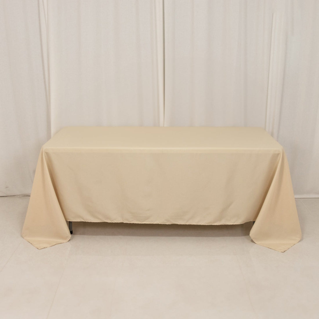 Beige tablecloth draped over a table in a studio setting