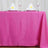 Pink tablecloth draping over a table set for dining with plates and folded napkins.