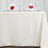 Elegant dining table setting with white tablecloth and floral accents.