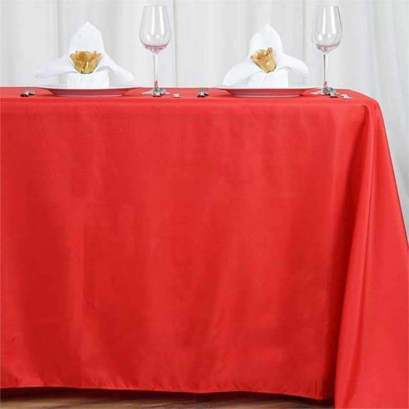 Red tablecloth elegantly draped on a table set for dining.