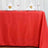 Red tablecloth elegantly draped on a table set for dining.