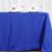 Blue tablecloth draped over a table, styled with glasses and napkins.