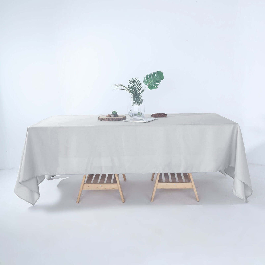 Neutral tablecloth draped over a wooden table with decorative elements