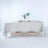 Neutral tablecloth draped over a wooden table with decorative elements