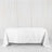 White table covered with a clean tablecloth in a minimalist setting.