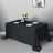 Black tablecloth draped over a table set with plates and a floral centerpiece.