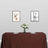 Dining table with brown tablecloth, floral centerpiece, and framed deer art on the wall.