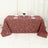 Geometric patterned tablecloth in maroon with gold lines on a dining table.