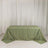 Green tablecloth with gold geometric design on a plain backdrop.