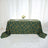Green tablecloth with geometric gold lines on a styled table setting.