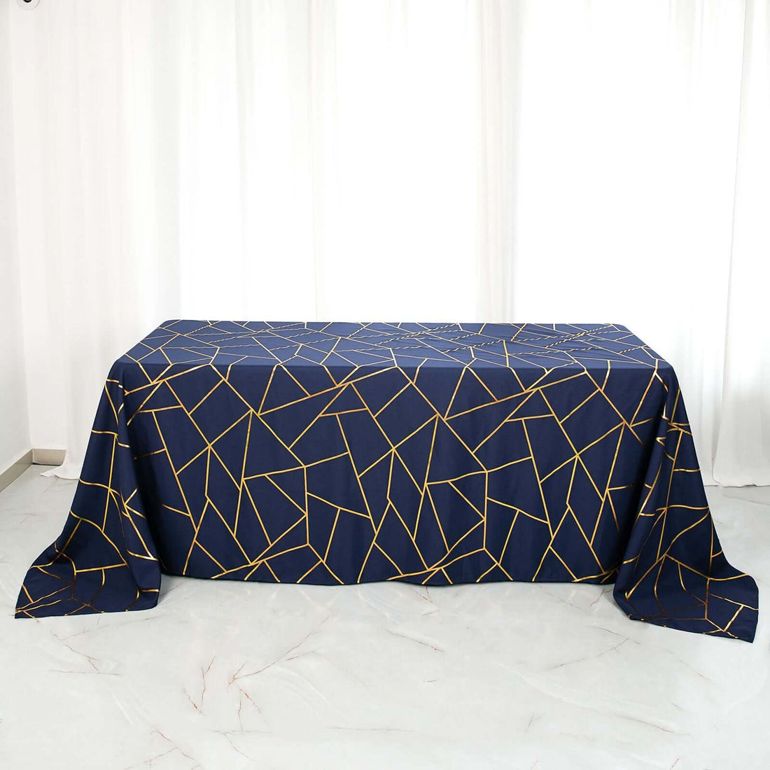 Navy tablecloth with geometric gold pattern on a plain table