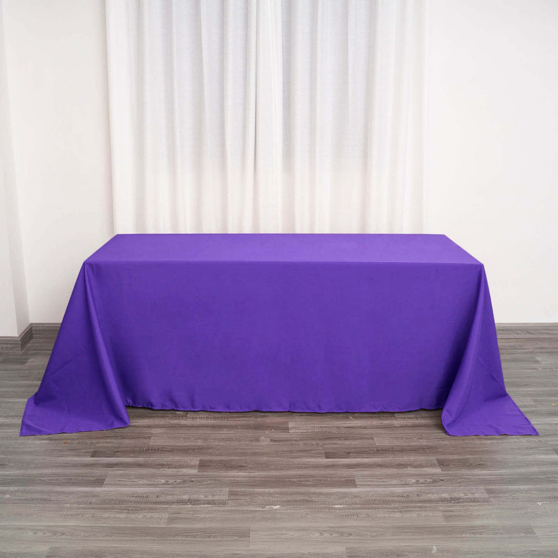 Purple tablecloth draped over a table in a minimalist setting.
