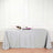Elegant gray tablecloth draped over a table with wine and flowers.