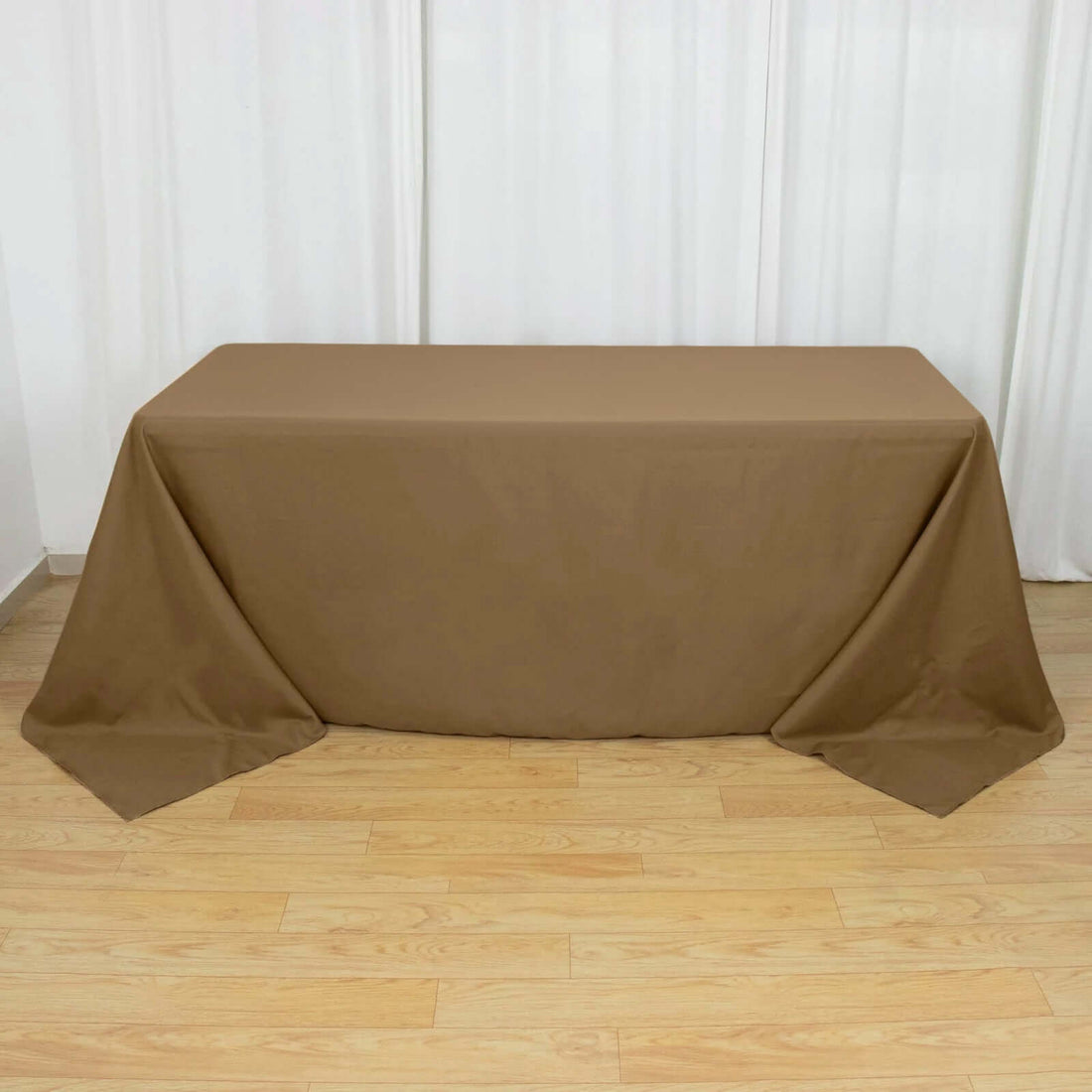 Brown tablecloth draped over a table in an indoor setting.