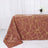 Brown tablecloth with gold geometric pattern on a table.