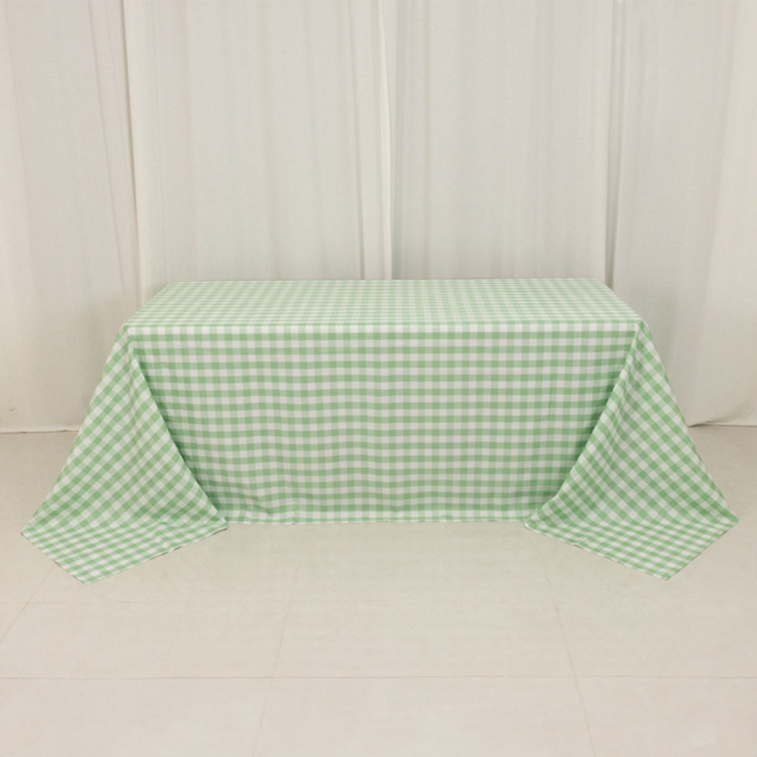 Green gingham tablecloth on a table, showcasing a checkered pattern.