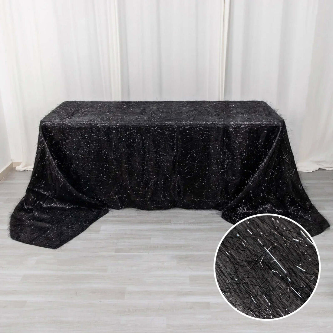 Black tablecloth with sparkling texture, ideal for elegant events.