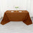 Brown tablecloth draped over a table set for dining with plates and glasses.