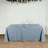Blue tablecloth draped over a table with plates and glasses on top.