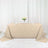 Elegant beige tablecloth draped over a table with floral centerpiece and tableware.