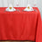 Red tablecloth set with elegant napkin folds and place settings.