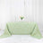 Mint green tablecloth with gold geometric pattern on a white table.