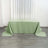 Green tablecloth draped on a table against a neutral backdrop.