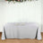 Gray tablecloth draped over a table with plates and glasses on it.