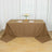 Brown tablecloth draping over a table set for dining with plates and flowers.