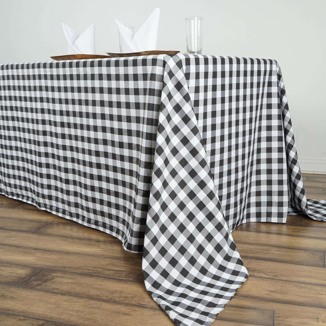 Black and white checkered tablecloth draped over a wooden table.
