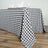 Black and white checkered tablecloth draped over a wooden table.