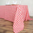Red and white checkered tablecloth draped over a wooden table.