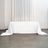 White tablecloth draped over a table in a minimalist setting.