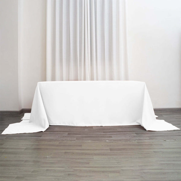 White tablecloth draped over a table in a minimalist setting.