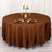 Brown round tablecloth draped over a table set for dining.