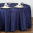 Navy blue tablecloth with elegant napkin folds on a round table setting.
