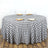 Black and white checkered tablecloth on a round table with plates and glasses.