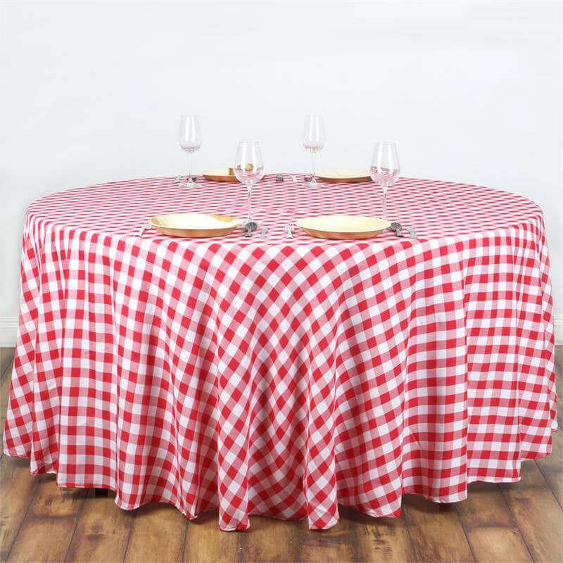 Red and white checkered tablecloth on a round table with place settings.