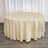 Round tablecloth with geometric pattern in cream and gold.