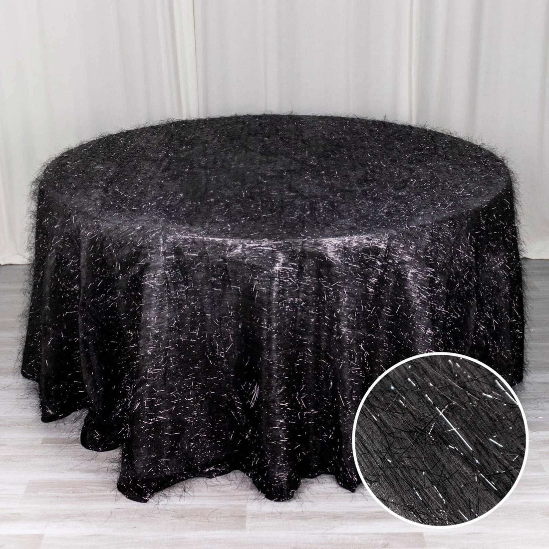 Black tablecloth with textured sparkle detail, ideal for formal events.