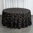Black tablecloth with gold geometric pattern on a round table.