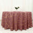 Elegant maroon tablecloth with gold geometric patterns on a round table.