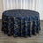 Round navy tablecloth with gold geometric pattern on a wooden surface.