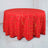 Red tablecloth with a gold geometric pattern on a round surface.